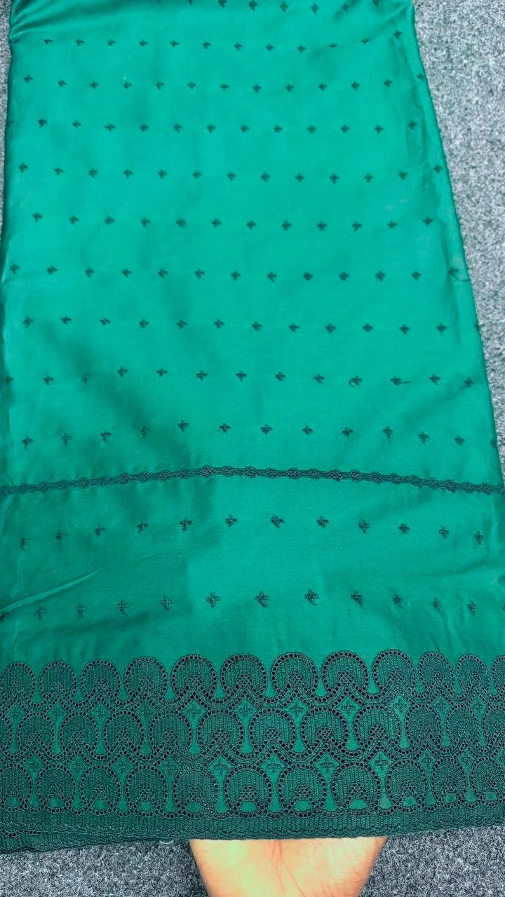 Teal fabric with embroidered lace edge
